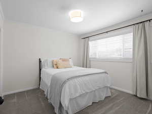 Bedroom featuring carpet, crown molding, and baseboards