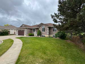 Ranch-style home with driveway, a garage, and brick siding
