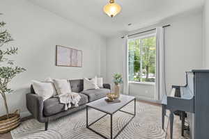 Living room featuring light colored carpet and baseboards
