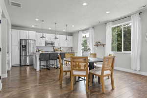 Dining room featuring recessed lighting, dark wood-type flooring, and baseboards