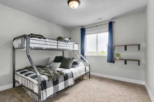 Bedroom with carpet floors and baseboards