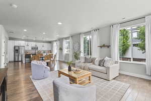 Living room featuring recessed lighting, hardwood / wood-style flooring, and baseboards