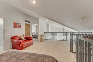 Loft Living area featuring new traffic master carpet, recessed lighting, vaulted ceiling, and baseboards.