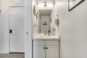 Half Bathroom on Main Floor with custom vanity and quartzite counters.