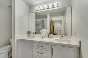 Newly Remodeled Bathroom with new custom cabinetry double vanity, and new flooring.