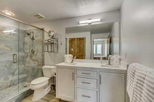 Completely remodeled Spa Like En Suite Bathroom with Walk In Shower w/ Glass Surround, stunning tile and new Delta faucets, Custom double sink vanity with Quartzite Counters and Delta faucets, Kohler toilet  w/ WhisperCore LVP flooring.
