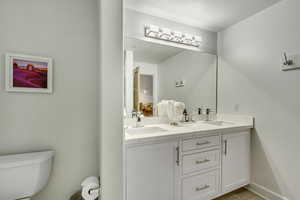 Newly Remodeled Bathroom with new custom cabinetry double vanity, and new flooring.