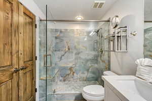 Full remodeled 8' x 11' bathroom in Private Main Level Suite with new custom double vanity, quartzite counters, glass surround,all new  fixtures and LVP flooring.