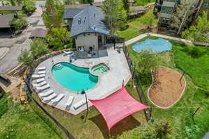 View of pool featuring a patio area and a pool with spa hot tub for fun and enjoyment.