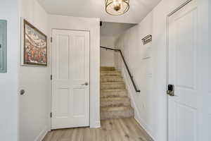 Foyer and Hall Coat Closet next to Stairs and Front Door.