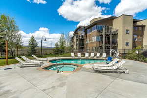 Club House Community pool featuring a community hot tub and a patio.