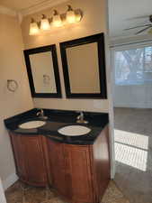 Full bathroom featuring ornamental molding, a ceiling fan, and double vanity