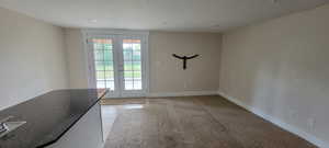 Doorway to outside with a textured ceiling, baseboards, french doors, and recessed lighting