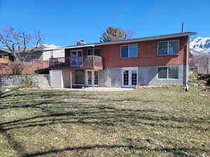 Rear view of house featuring french doors, stairs, a yard, a deck with mountain view, and a patio area