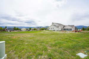 View of yard featuring an attached garage and a mountain view