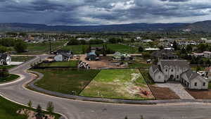 Aerial perspective of suburban area with a mountainous background and property parcel outlined