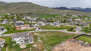 Aerial view of property's location with a mountainous background and nearby