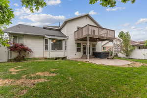Back of property featuring a patio, a wooden deck, a shingled roof, a hot tub, and stairs