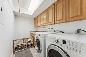 Washroom with cabinet space and washer and clothes dryer
