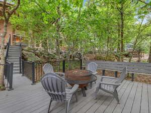 Wooden terrace with a fire pit and stairs