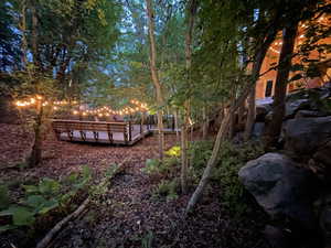 View of yard with a wooden deck