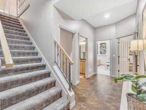Foyer featuring stairs, baseboards, recessed lighting, and stone finish flooring
