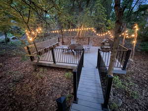 Wooden deck featuring an outdoor fire pit and stairs