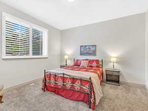 Bedroom featuring carpet flooring and baseboards