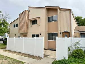 View of side of property featuring fence