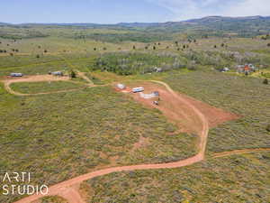 Aerial overview of property's location with rural landscape and a mountain backdrop