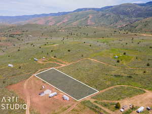View of rural area with property parcel outlined and a mountain backdrop