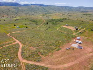 Aerial view of property and surrounding area with a mountainous background and rural landscape