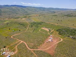Aerial view of property's location featuring rural landscape and a mountain backdrop