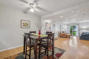 Dining area with wood finished floors, baseboards, a textured ceiling, recessed lighting, and ceiling fan