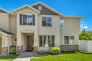 View of property with stone siding and stucco siding