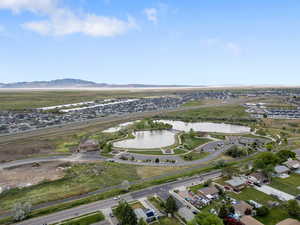 View of property location featuring a water and mountain view and nearby suburban area