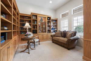 Sitting room with light carpet and recessed lighting