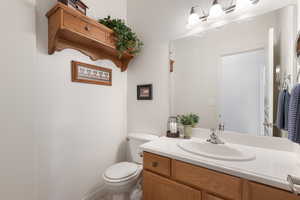 Half bath featuring toilet and vanity