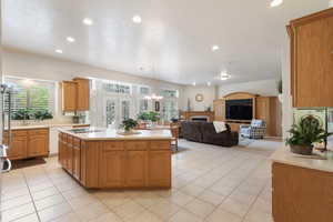 Kitchen featuring light countertops, recessed lighting, a center island, light tile patterned floors, and black electric cooktop