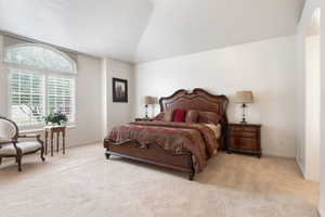 Bedroom with carpet, baseboards, and arched walkways