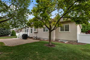 Rear view of house with a patio area and stucco siding