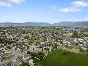 Aerial overview of property's location with a mountainous background and nearby suburban area