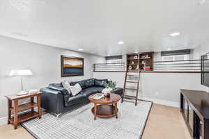 Carpeted living room featuring recessed lighting and baseboards