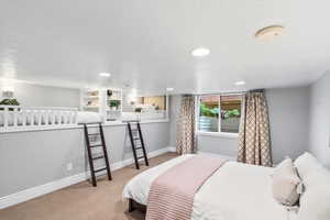 Bedroom with carpet flooring, baseboards, and recessed lighting