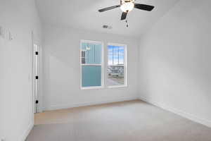 Unfurnished room featuring a ceiling fan, carpet flooring, and baseboards