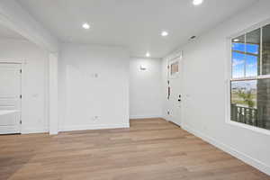 Empty room with recessed lighting, baseboards, and light wood-style floors