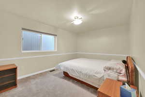 Carpeted bedroom featuring baseboards