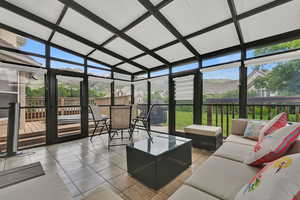 Sunroom / solarium featuring an outdoor living space and lofted ceiling