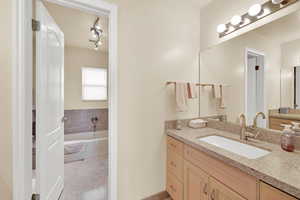 Bathroom featuring vanity and a garden tub