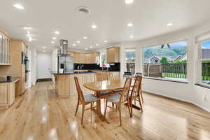 Dining space featuring baseboards, light wood finished floors, and recessed lighting